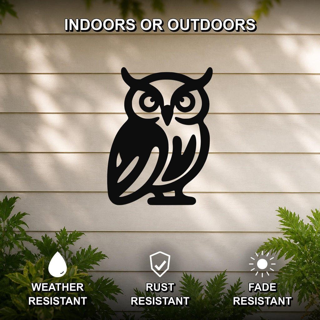 Black metal owl wall art with cutout details, mounted on a light-colored outdoor wall with greenery, weather resistant, rust resistant, and fade resistant.