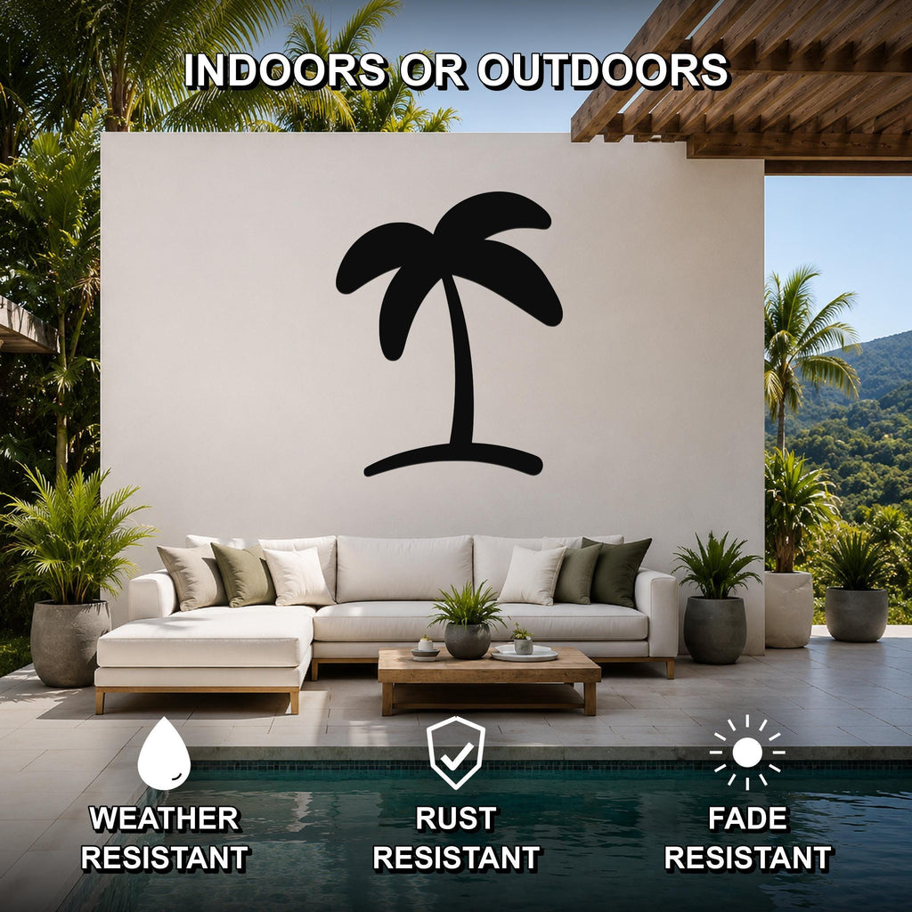 Black metal palm tree wall art silhouette mounted on a white outdoor wall above a sofa in a patio living area.