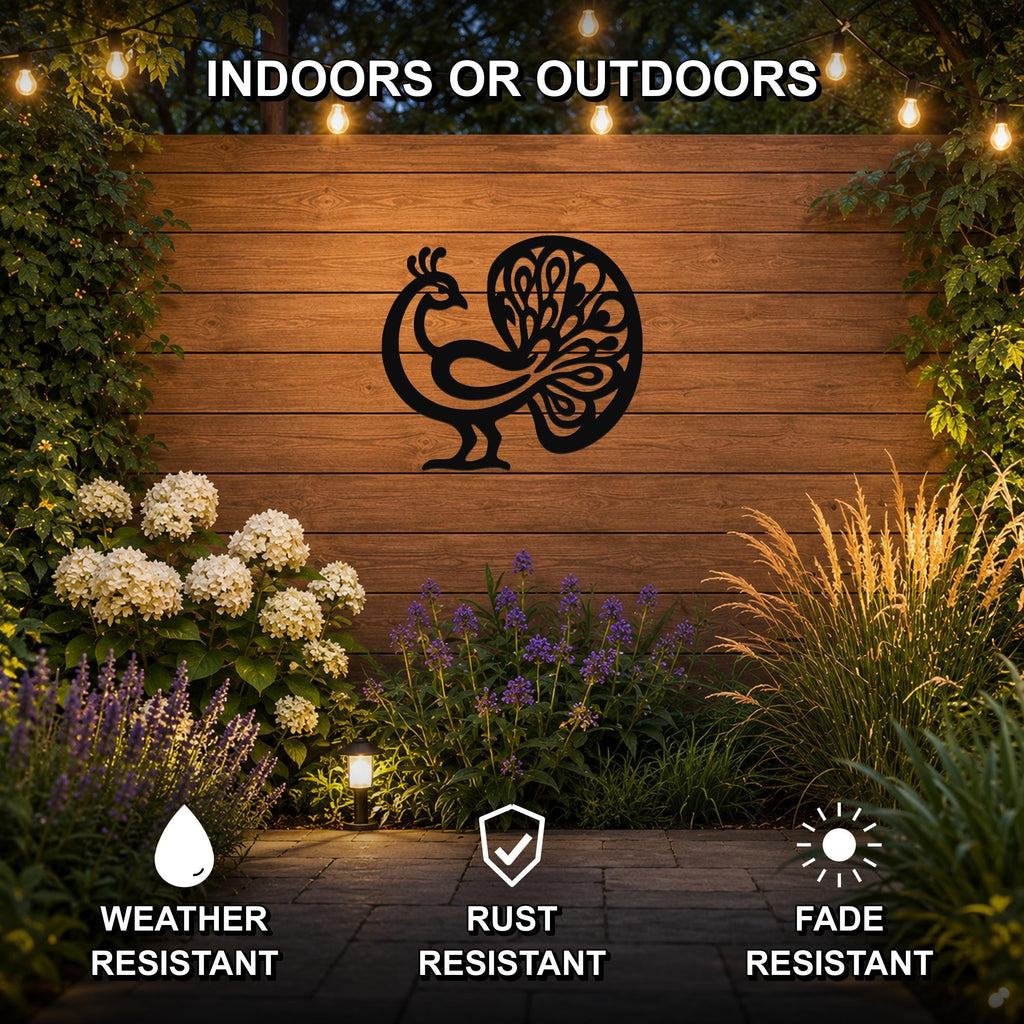 Black metal peacock wall art with intricate feather cutouts, mounted on a wooden outdoor wall surrounded by plants and string lights.