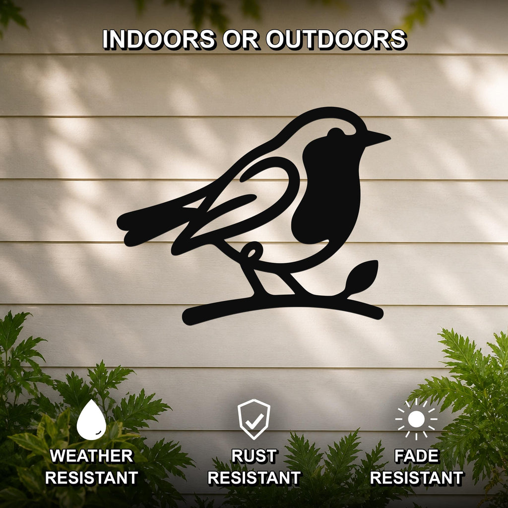Black metal robin wall art silhouette perched on a branch, mounted on a light-colored outdoor wall with greenery, weather resistant, rust resistant, and fade resistant.