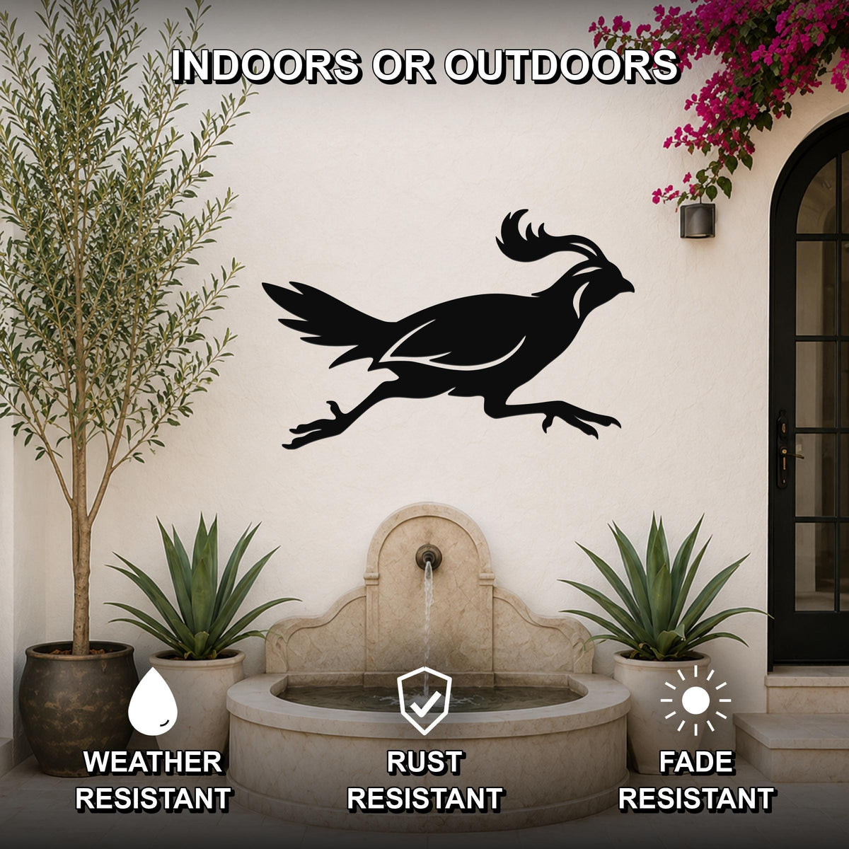 Black metal quail wall art silhouette with motion lines, mounted on an outdoor patio wall above a stone fountain, flanked by potted plants.