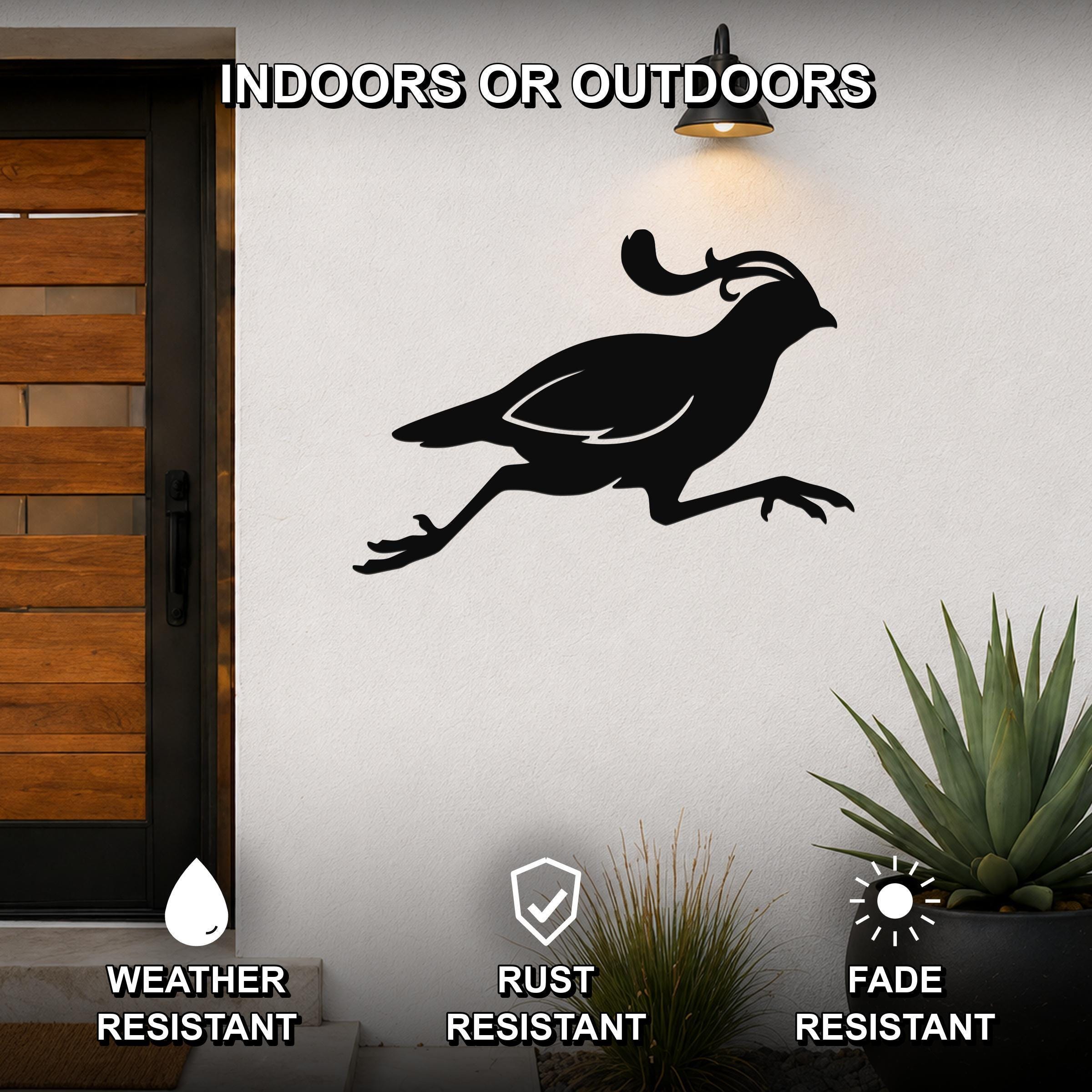 Black metal quail wall art in a running silhouette, mounted on an outdoor wall beside a wooden door and potted plants.