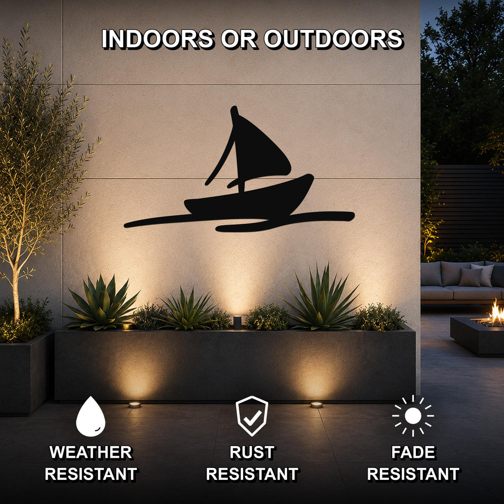 Black metal sailboat wall art silhouette mounted on an outdoor wall above a planter, with text indicating it is weather, rust, and fade resistant for indoor or outdoor use.