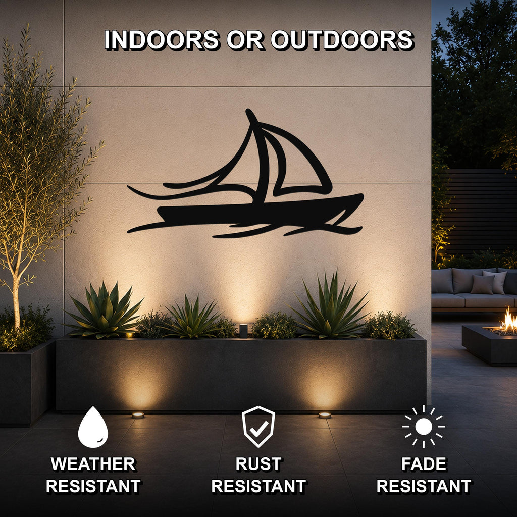 Black metal sailboat wall art with wave cutouts, mounted on an outdoor wall above a planter in a modern patio setting.