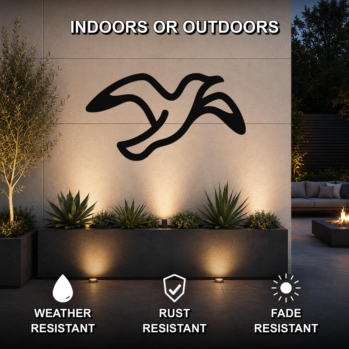 Black metal seagull wall art with motion-line cutouts, mounted on an outdoor wall above a planter in a patio setting.