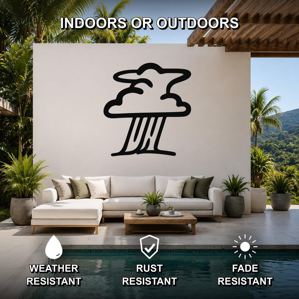 Black metal storm cloud wall art silhouette mounted on a white outdoor patio wall above a white sectional sofa, with palm trees and a pool in the background.