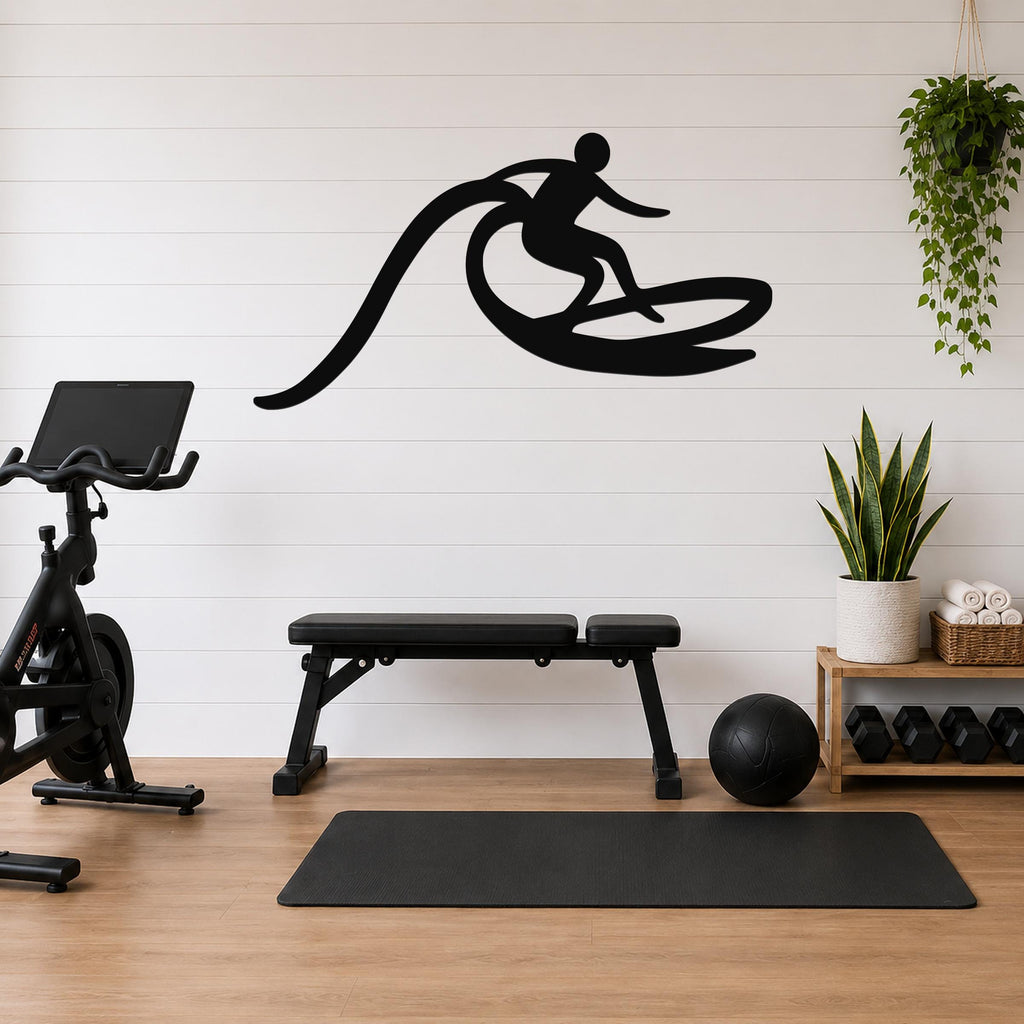 Black metal surfer wall art with motion-line cutouts, mounted on a white shiplap wall above a workout bench in a home gym.