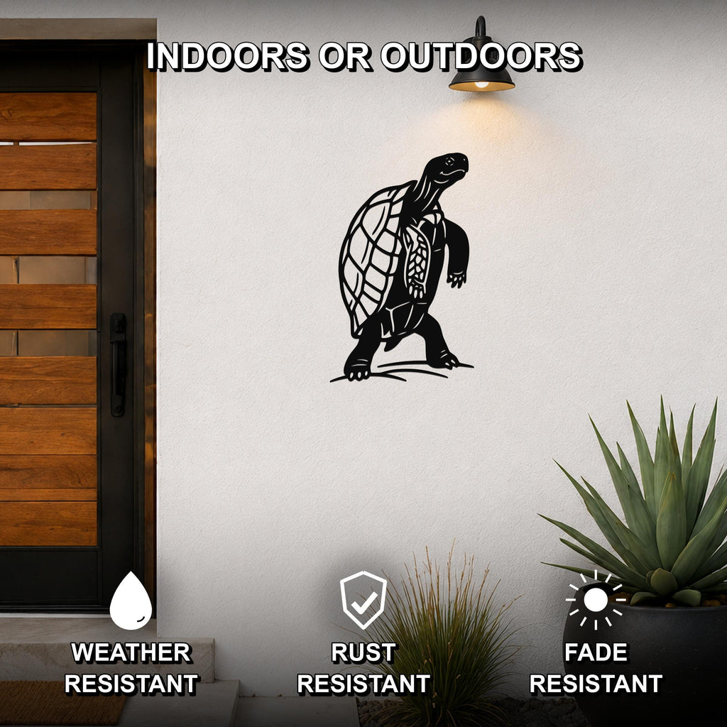 Black metal tortoise wall art with detailed shell cutouts, mounted on an outdoor wall beside a wooden door and potted plants.