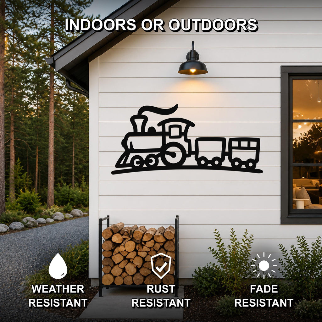 Black metal train wall art silhouette mounted on a white exterior wall above a firewood rack, with text indicating it is weather, rust, and fade resistant for indoor or outdoor use.