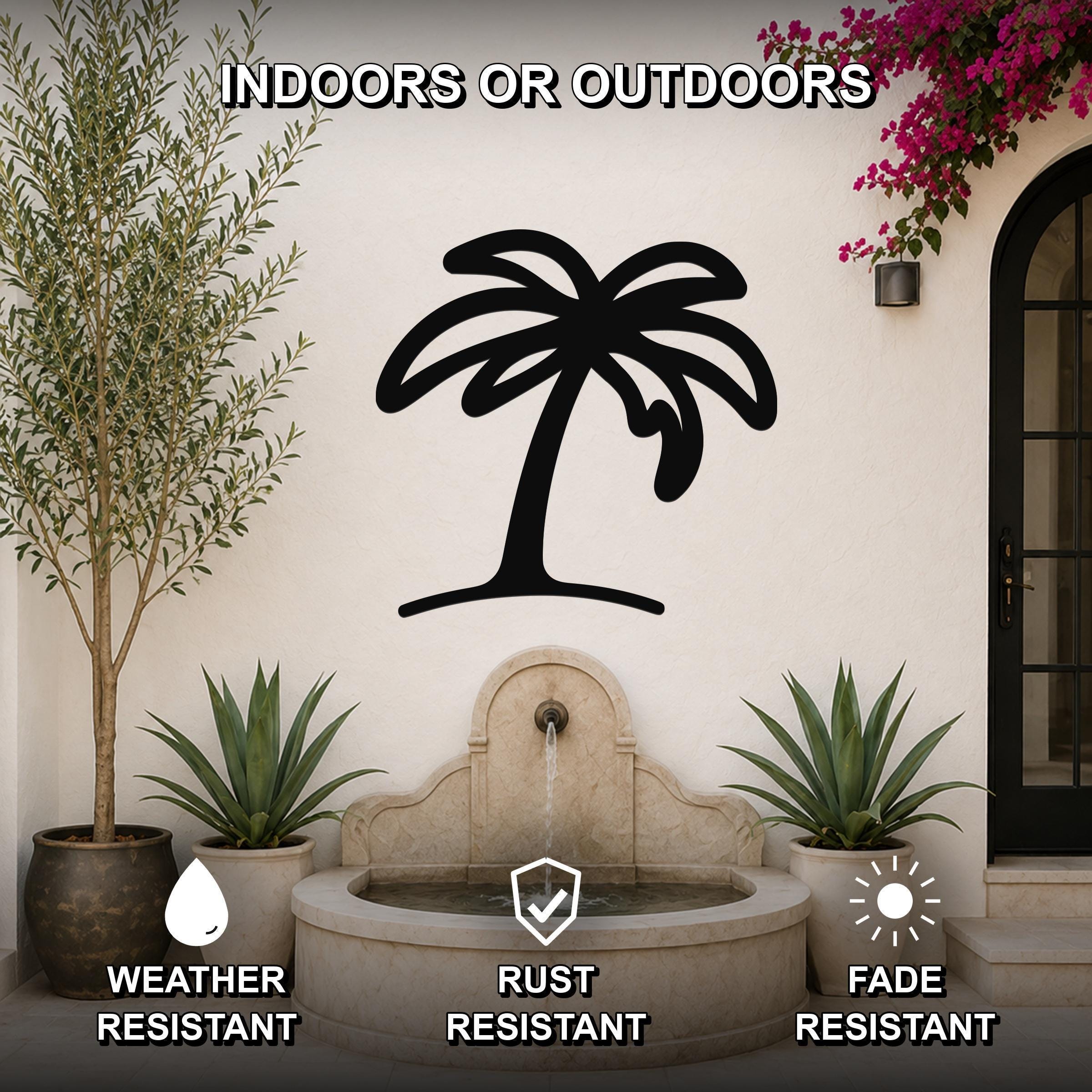 Black metal palm tree wall art with a silhouette design, mounted on an outdoor wall above a stone fountain, flanked by potted plants and a blooming vine.