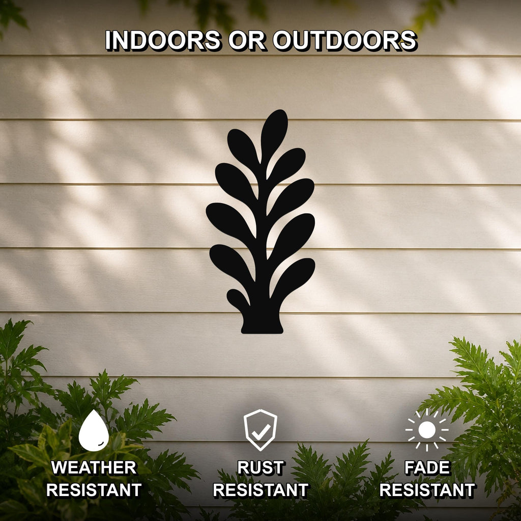 Black metal abstract botanical sprig wall art with leaf cutouts, mounted on a beige outdoor wall with greenery, weather resistant, rust resistant, and fade resistant.