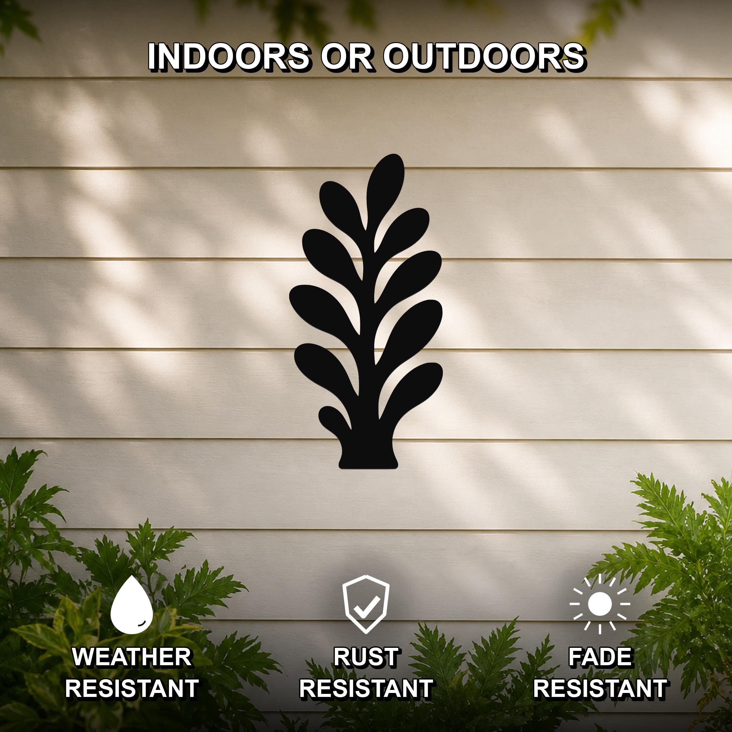 Black metal abstract botanical sprig wall art with leaf cutouts, mounted on a beige outdoor wall with greenery, weather resistant, rust resistant, and fade resistant.