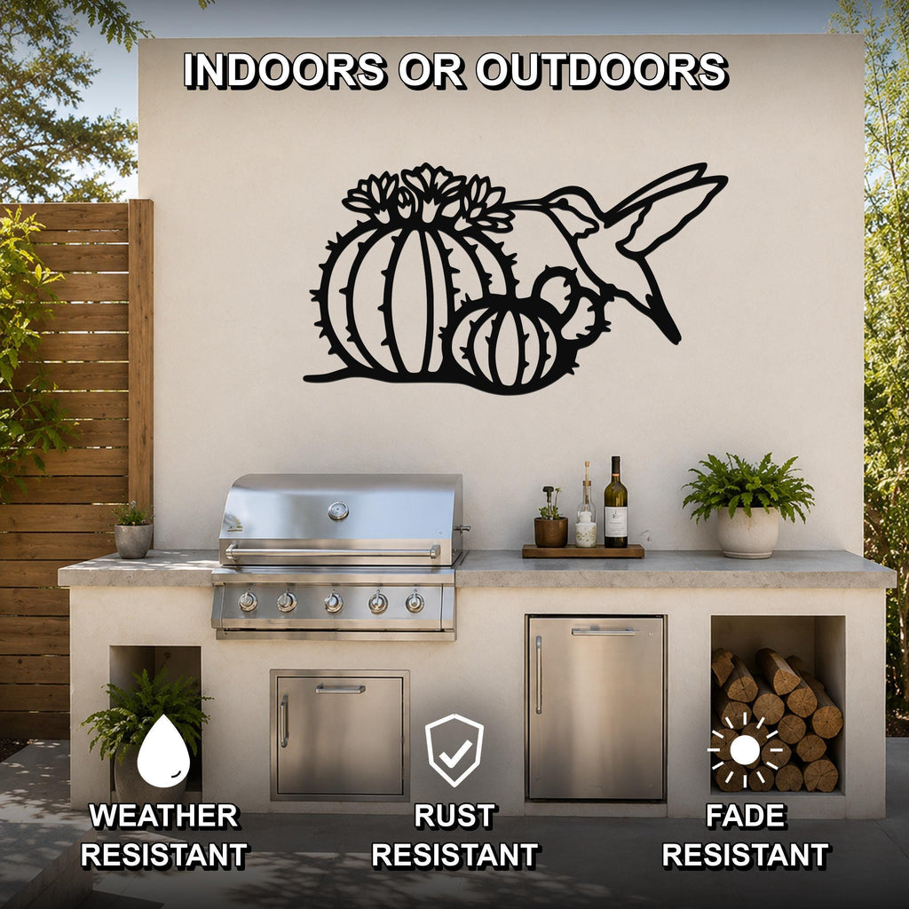Black metal wall art featuring a hummingbird and barrel cactus with flower cutouts, mounted on an outdoor patio wall above a kitchen counter.