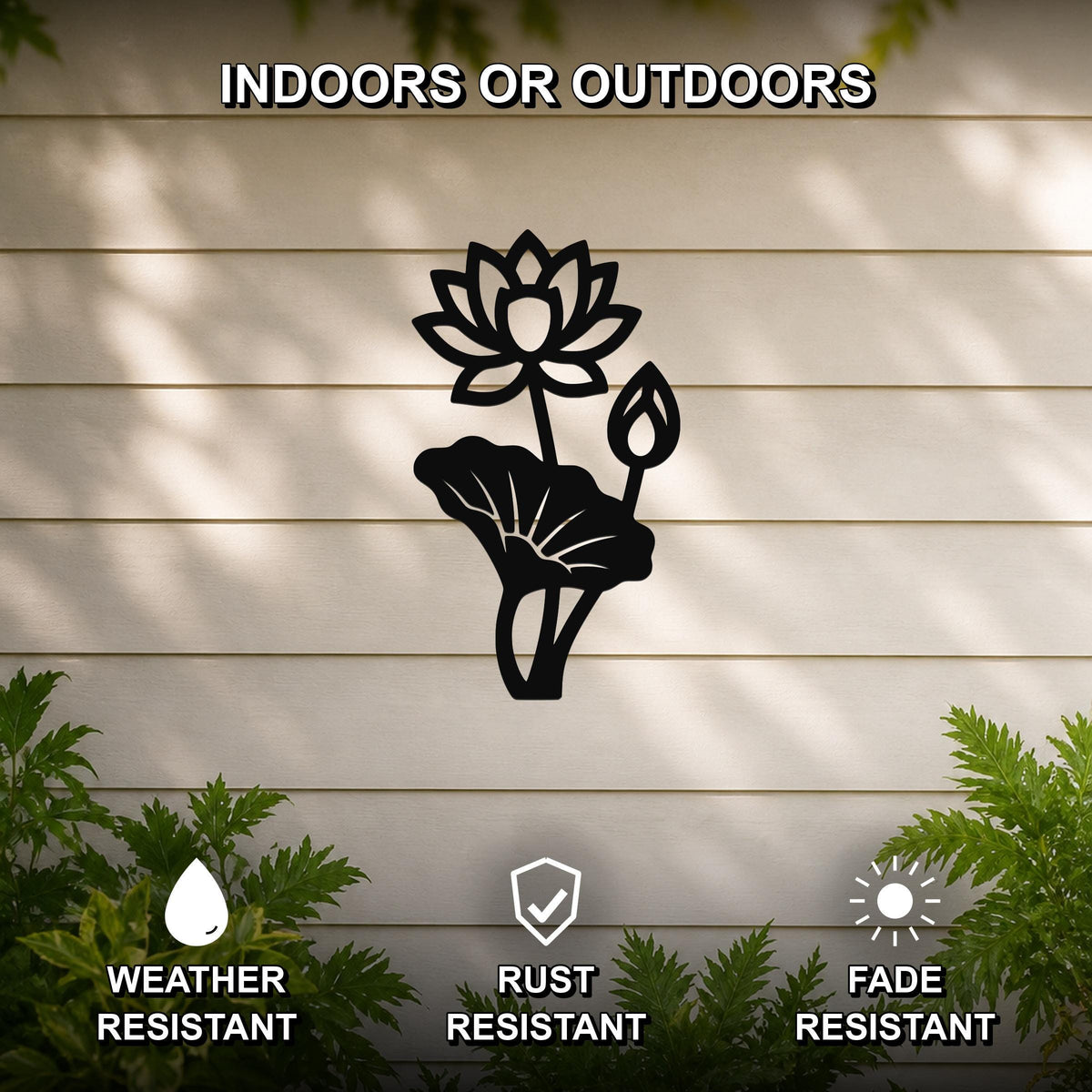 Black metal lotus flower wall art with a cutout design, mounted on a beige outdoor wall with greenery, weather resistant, rust resistant, and fade resistant.