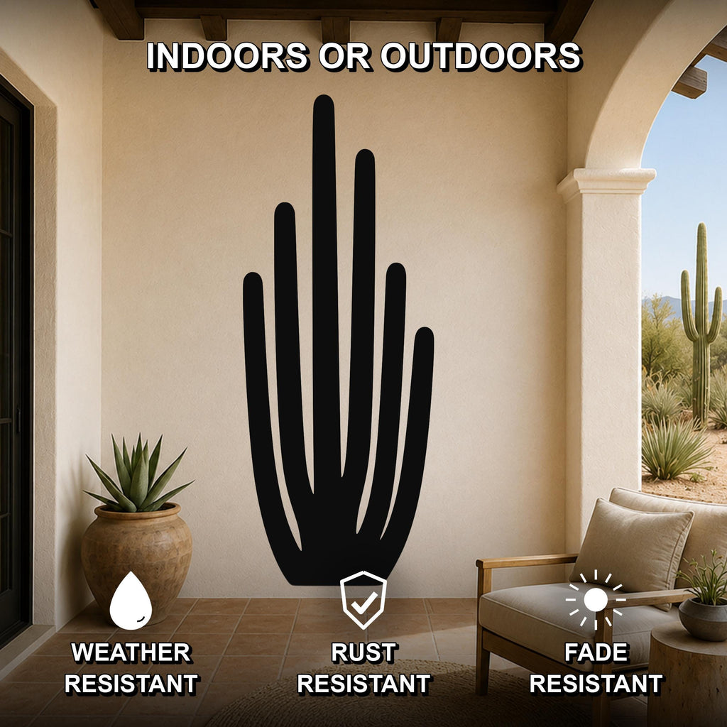 Black metal organ pipe cactus wall art with vertical spine cutouts, mounted on a beige patio wall above a wooden chair.