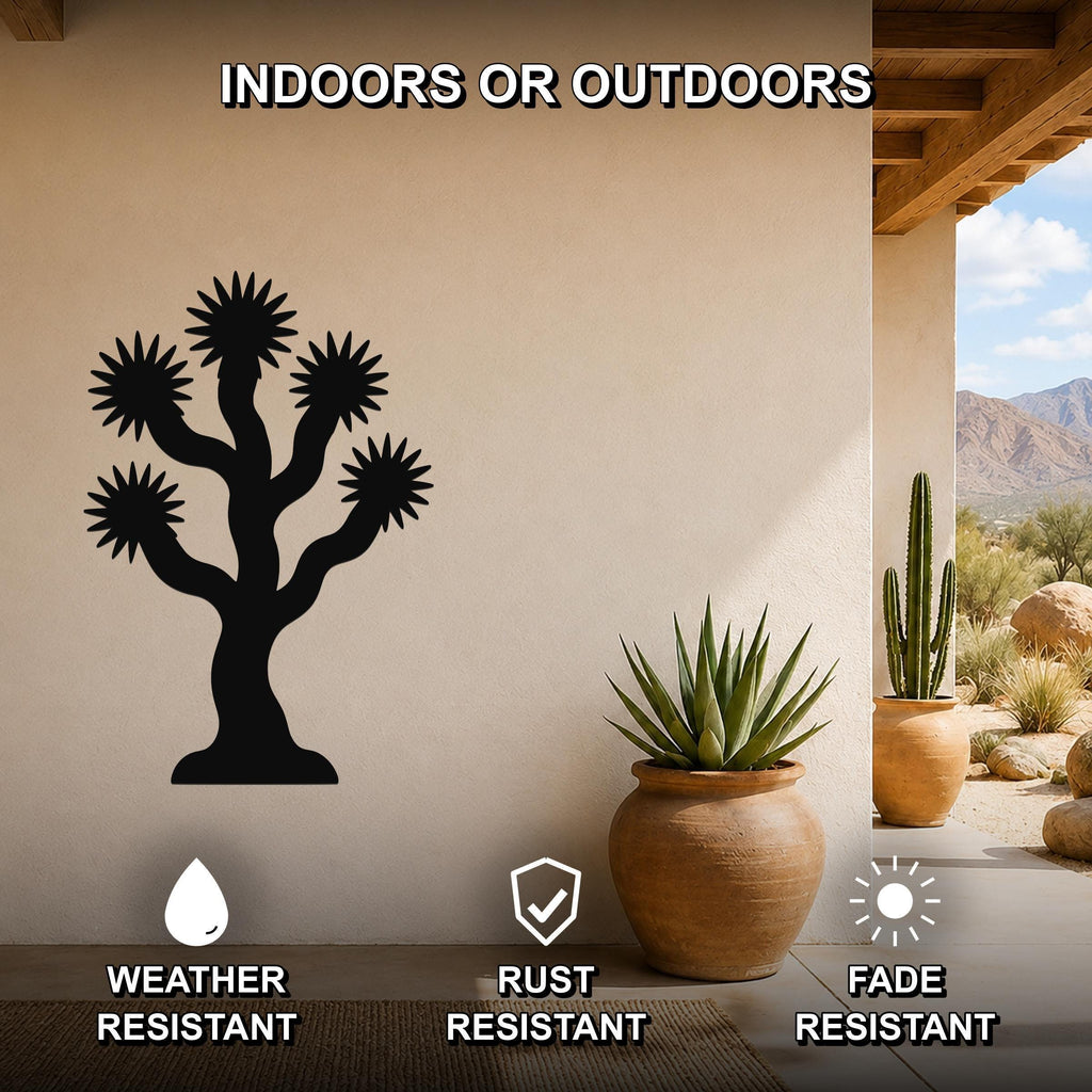 Black metal Joshua tree wall art with starburst cutouts, mounted on a beige outdoor patio wall above a potted succulent, weather, rust, and fade resistant.