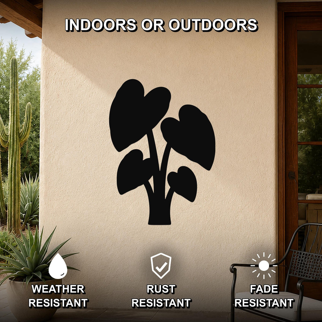 Black metal wall art of an elephant ear plant silhouette, mounted on an outdoor patio wall with cactus and potted plant nearby, weather, rust, and fade resistant.