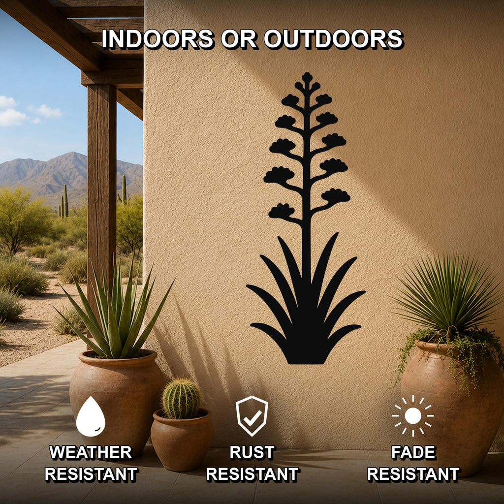 Black metal agave wall art with blooming flower cutout, mounted on an outdoor patio wall above potted plants.