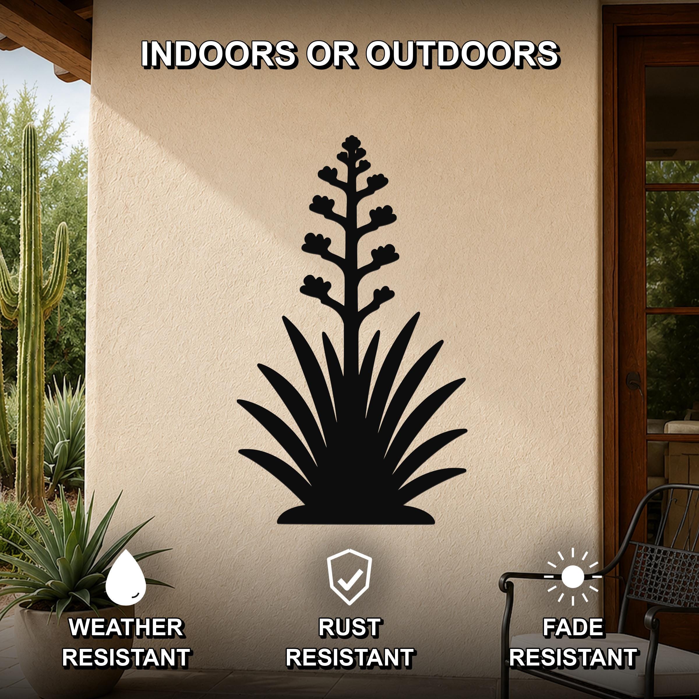 Black metal agave wall art with blooming flower cutout, mounted on an outdoor patio wall above a potted plant.