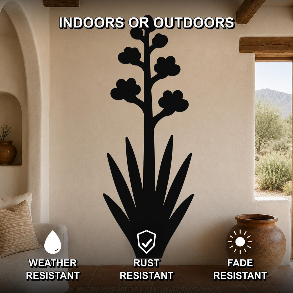 Black metal agave wall art with blooming flower silhouette, mounted on a beige living room wall above a sofa, weather, rust, and fade resistant.