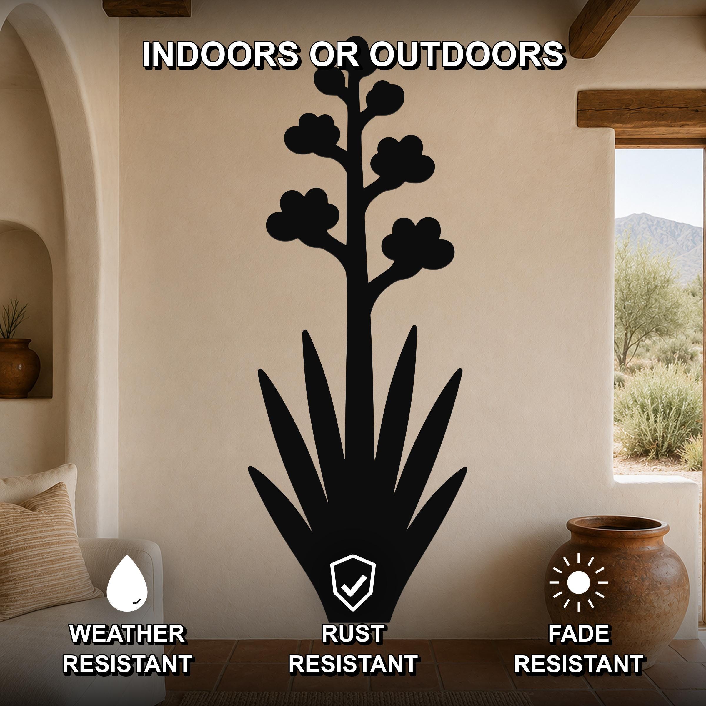 Black metal agave wall art with blooming flower silhouette, mounted on a beige living room wall above a sofa, weather, rust, and fade resistant.