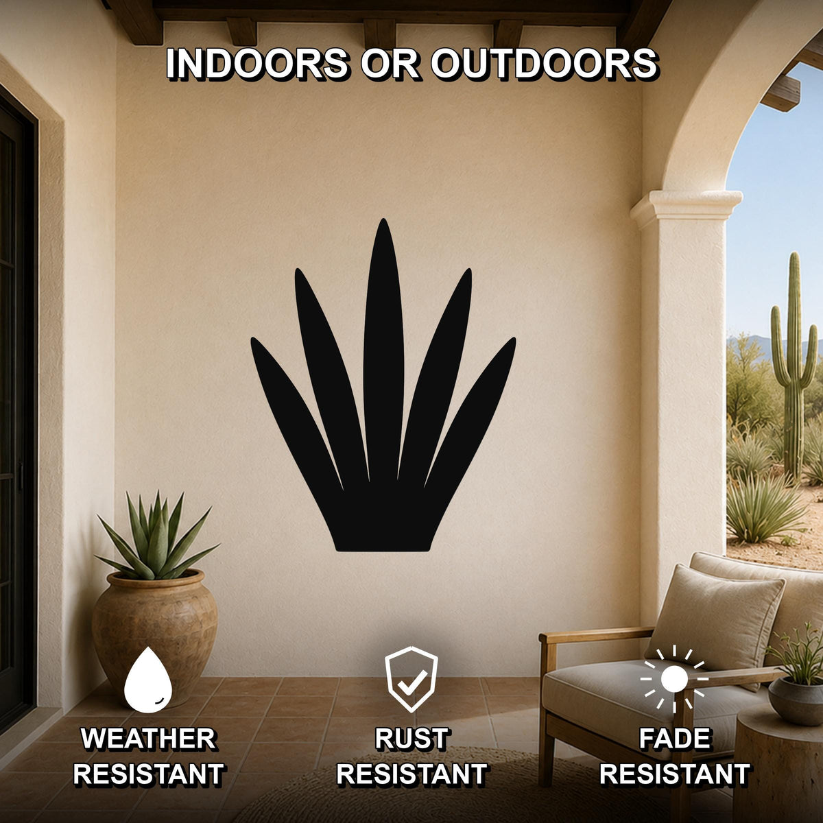 Black metal agave wall art silhouette mounted on a beige outdoor patio wall, displayed above a wooden chair with cushions and a potted succulent nearby.