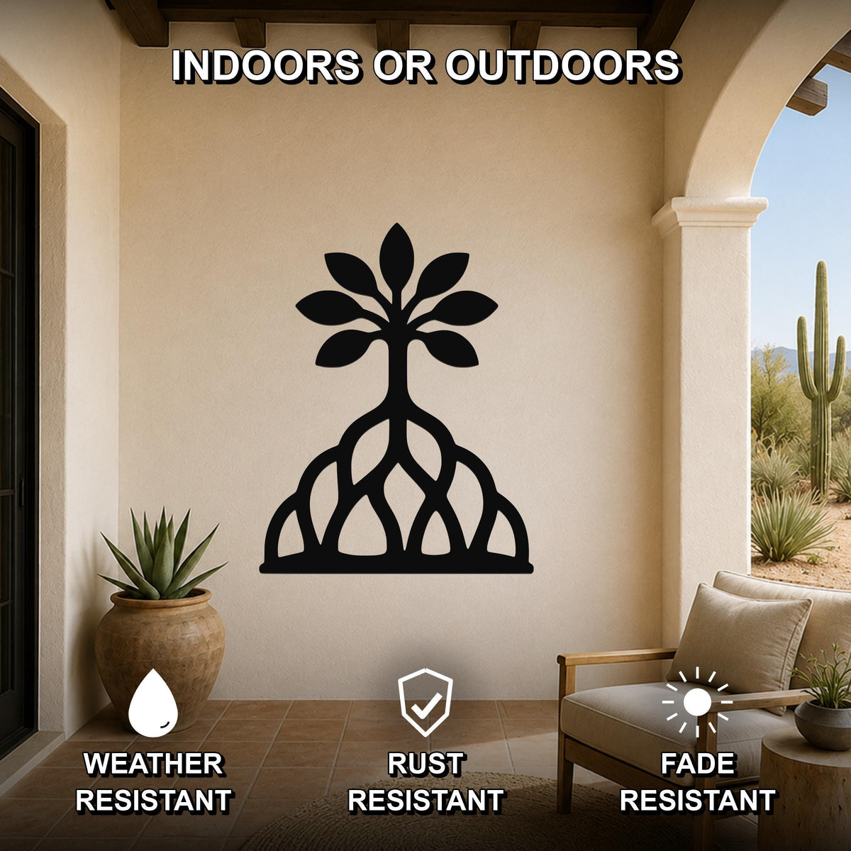 Black metal wall art in the shape of a tree with visible roots and leaf cutouts, mounted on a beige wall in a covered patio with outdoor furniture and potted plants.