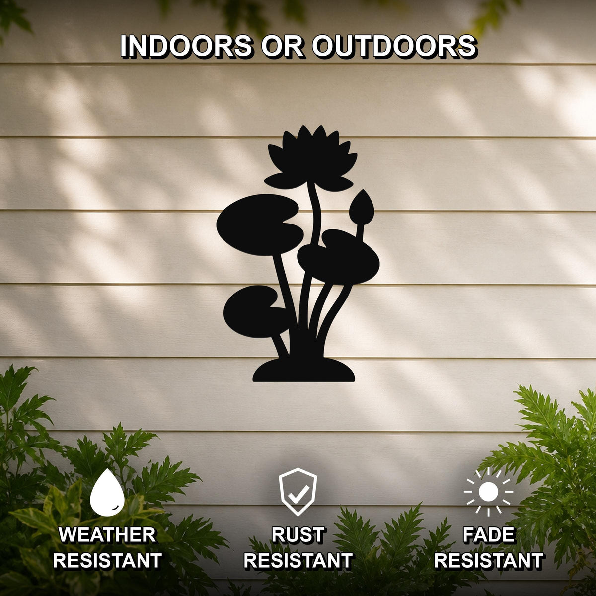 Black metal lotus water lily wall art silhouette with flower and leaf cutouts, mounted on a beige outdoor wall with greenery, weather, rust, and fade resistant.