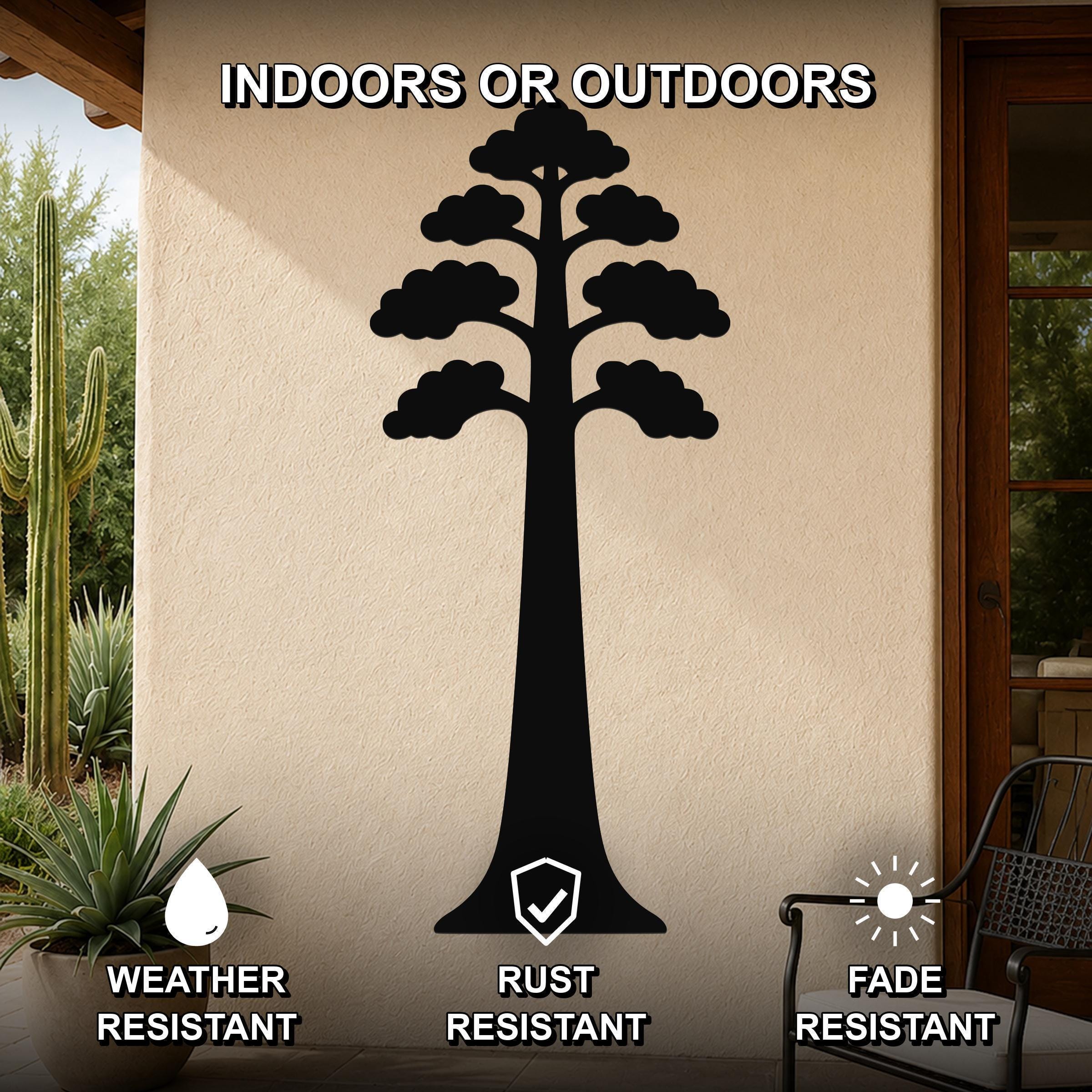 Black metal sequoia tree wall art with layered branch cutouts, mounted on an outdoor patio wall with cactus and potted plant nearby.