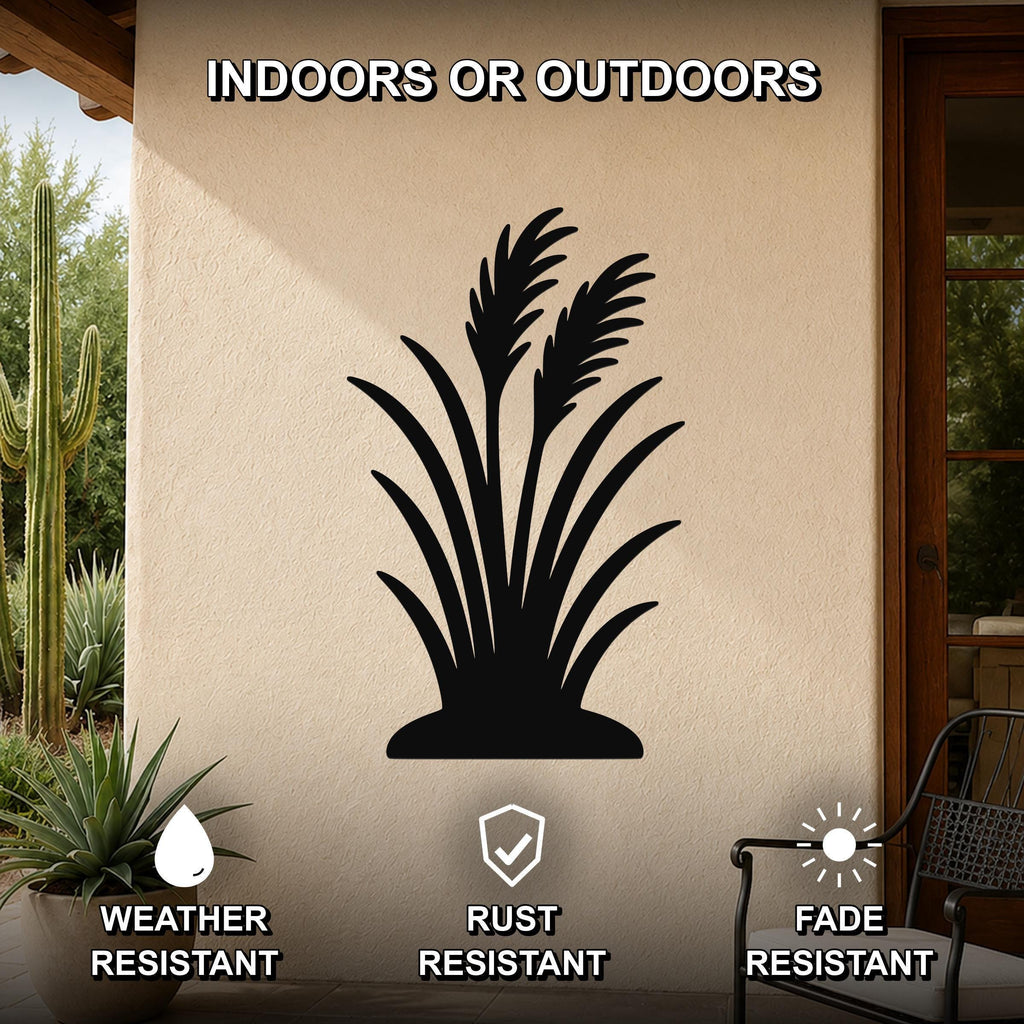 Black metal wall art featuring a wild grass silhouette, mounted on an outdoor patio wall with cactus and potted plant nearby, weather, rust, and fade resistant.