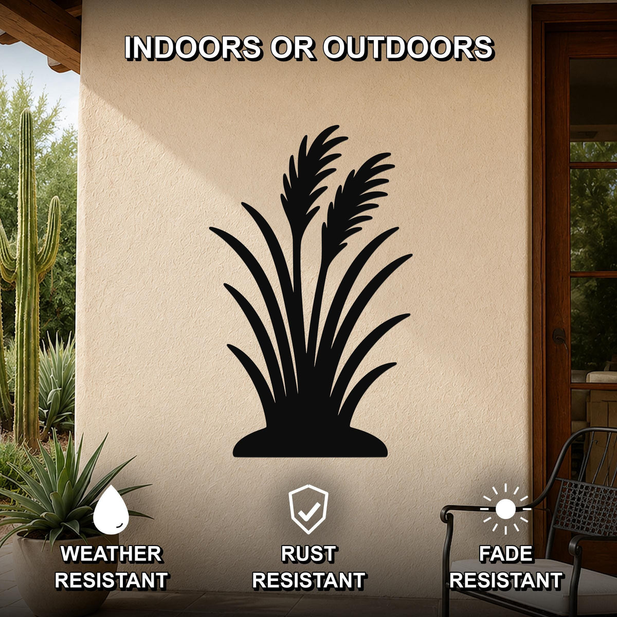 Black metal wall art featuring a wild grass silhouette, mounted on an outdoor patio wall with cactus and potted plant nearby, weather, rust, and fade resistant.