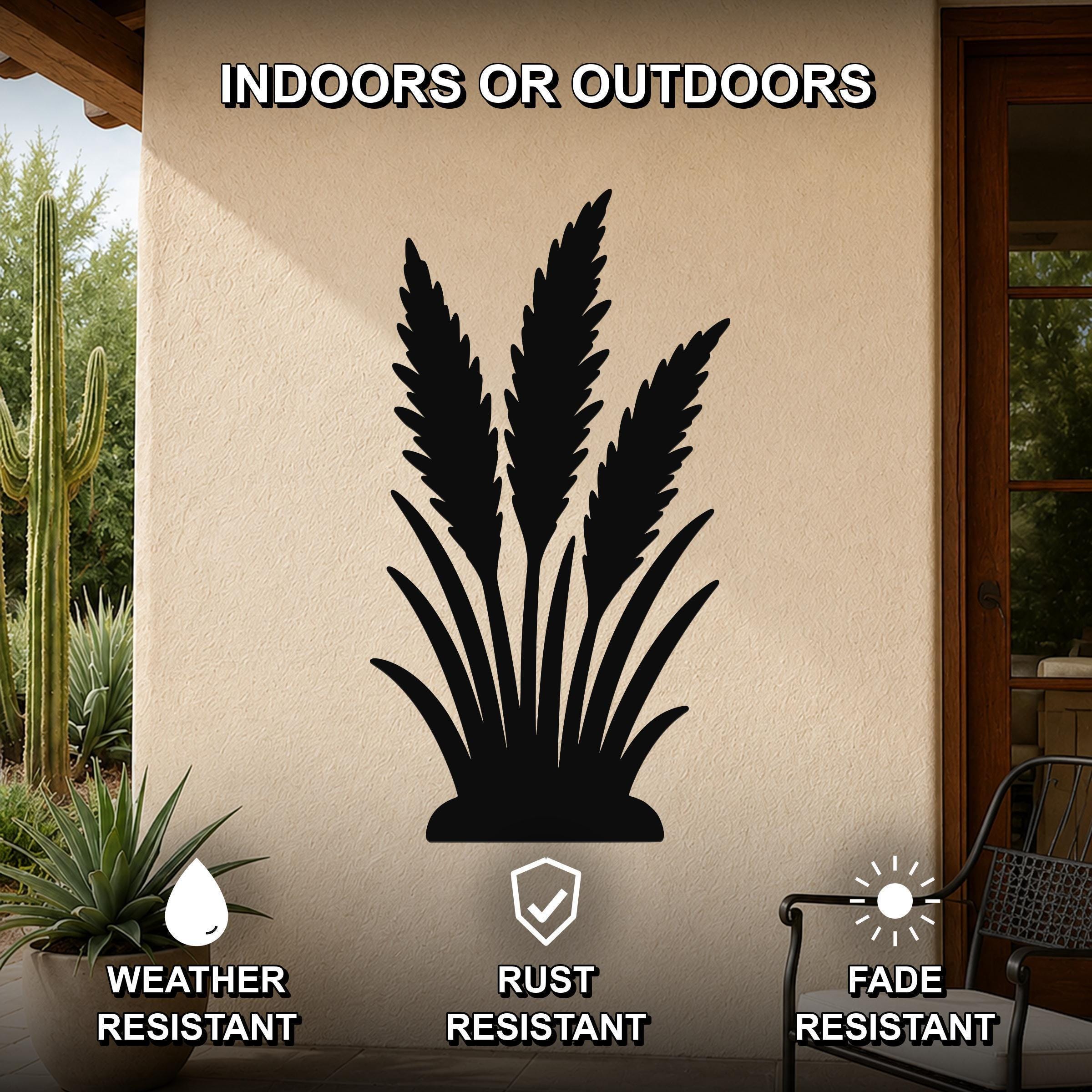 Black metal wall art in a wild grass silhouette design, mounted on an outdoor patio wall with cactus and potted plant nearby, weather, rust, and fade resistant.