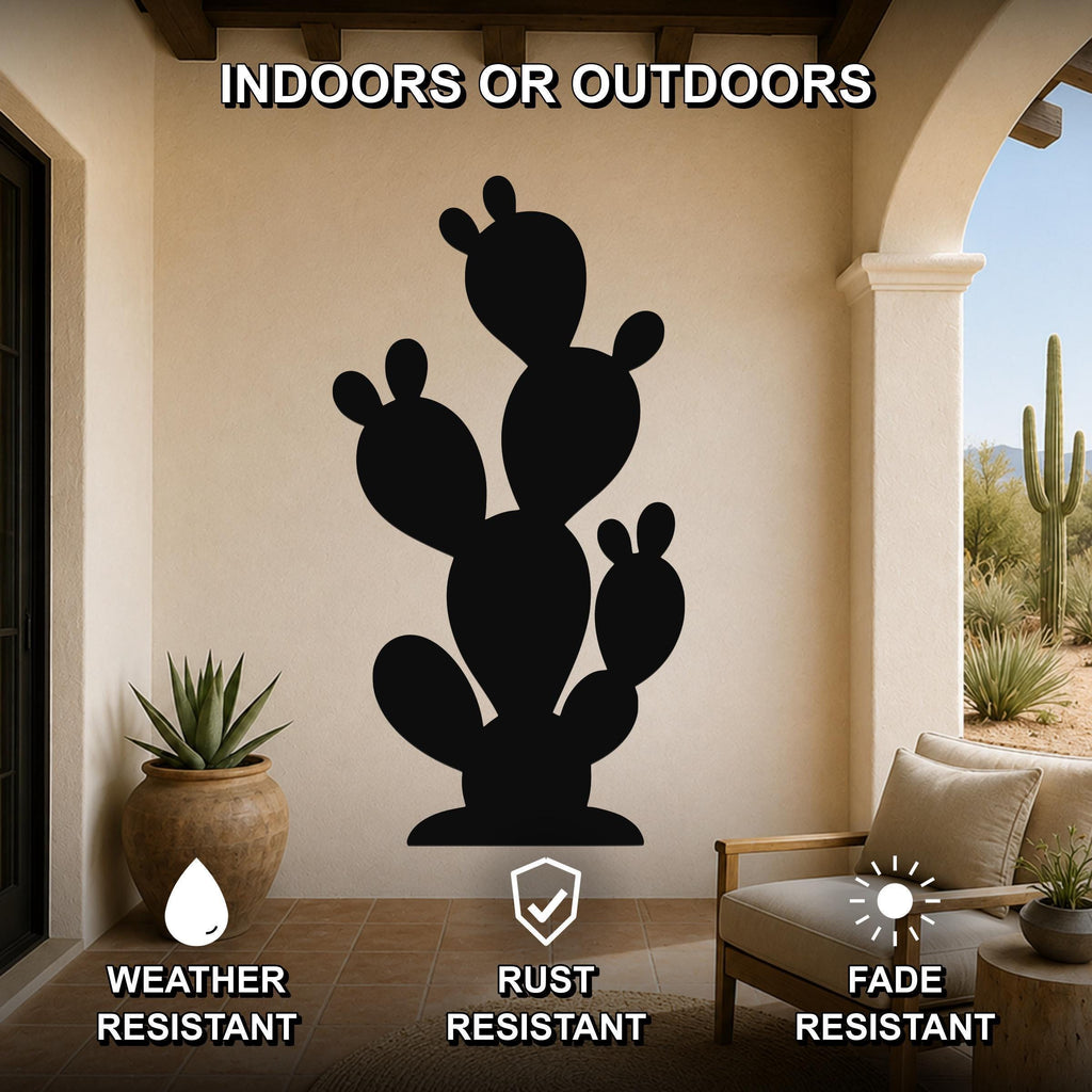 Black metal prickly pear cactus wall art with multiple pads and cutout details, mounted on a beige patio wall above a wooden chair and potted plant.