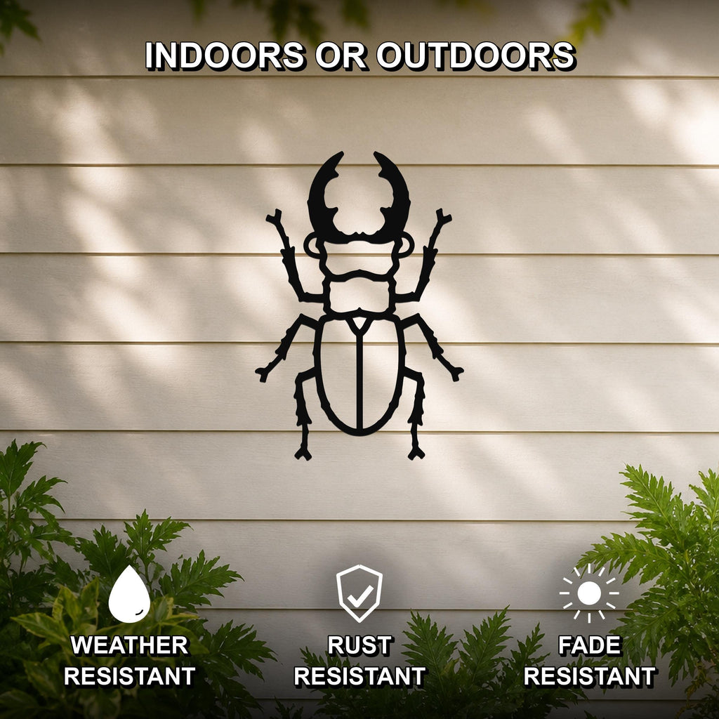 Black metal beetle wall art silhouette with detailed cutouts, mounted on a light-colored outdoor wall with greenery, weather, rust, and fade resistant.