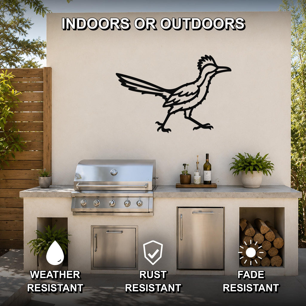 Black metal roadrunner wall art with motion-line cutouts, mounted on an outdoor patio wall above a grill and counter.