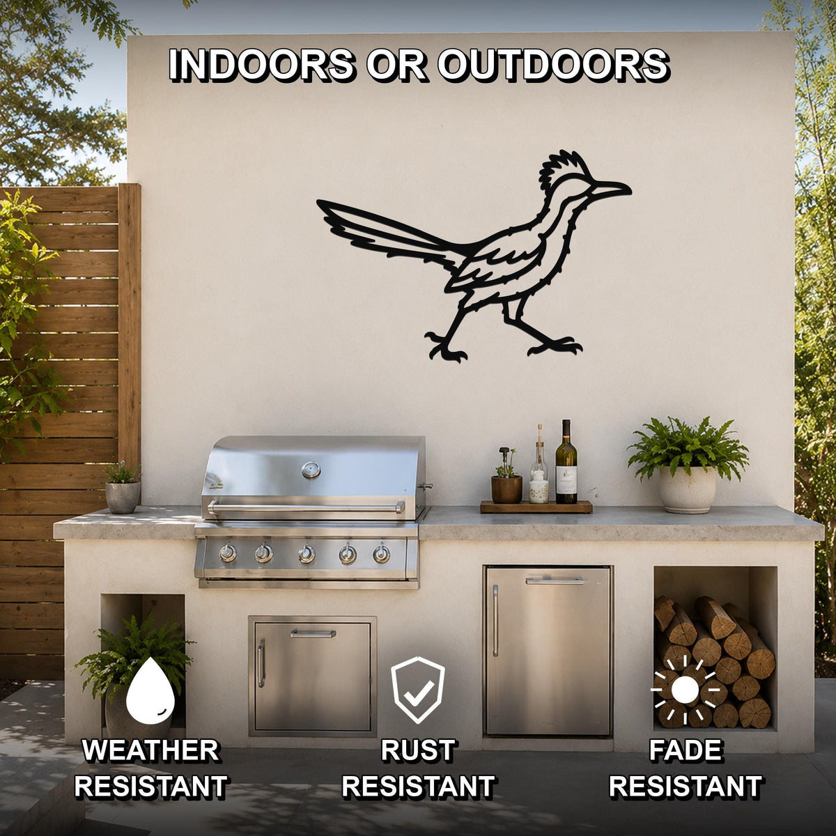 Black metal roadrunner wall art with motion-line cutouts, mounted on an outdoor patio wall above a grill and counter.