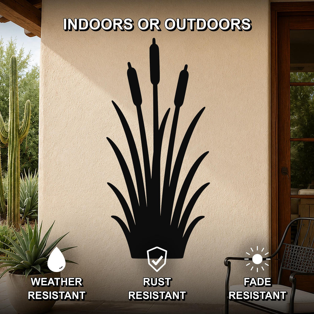 Black metal cattail wall art silhouette with three seed heads, mounted on an outdoor patio wall above a potted plant.