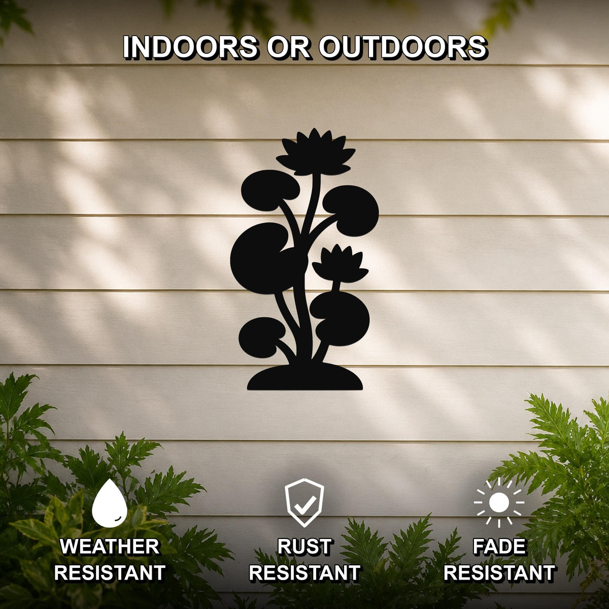 Black metal lotus water lily wall art with flower and leaf cutouts, mounted on a beige outdoor wall with greenery, weather, rust, and fade resistant.