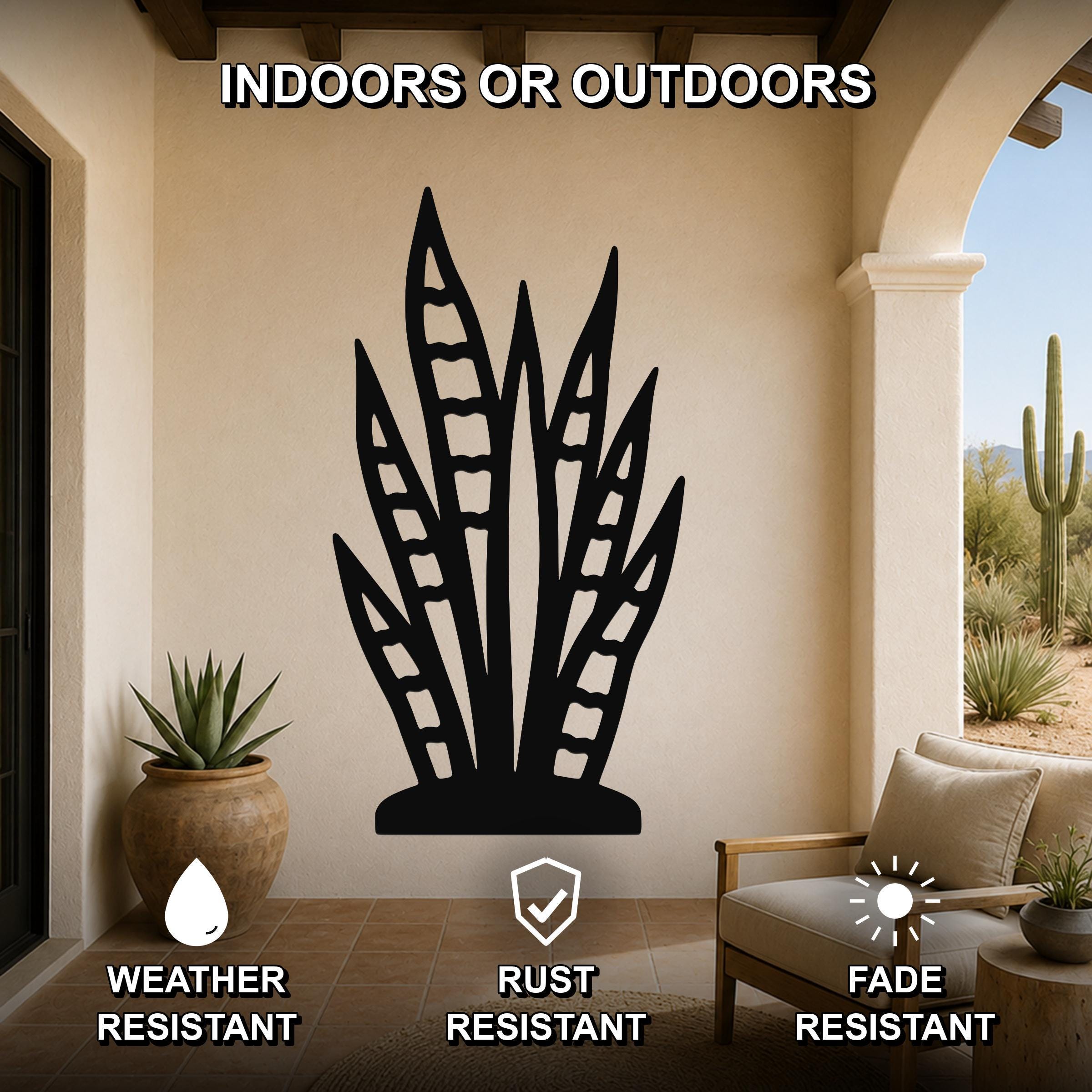 Black metal snake plant wall art with leaf cutouts, mounted on a beige outdoor patio wall above a potted plant and lounge chair.