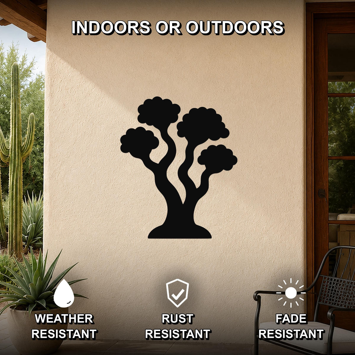 Black metal tree wall art with a silhouette design of three curved trunks and rounded canopies, mounted on an outdoor patio wall with cactus and potted plant nearby, labeled as weather, rust, and fade resistant.