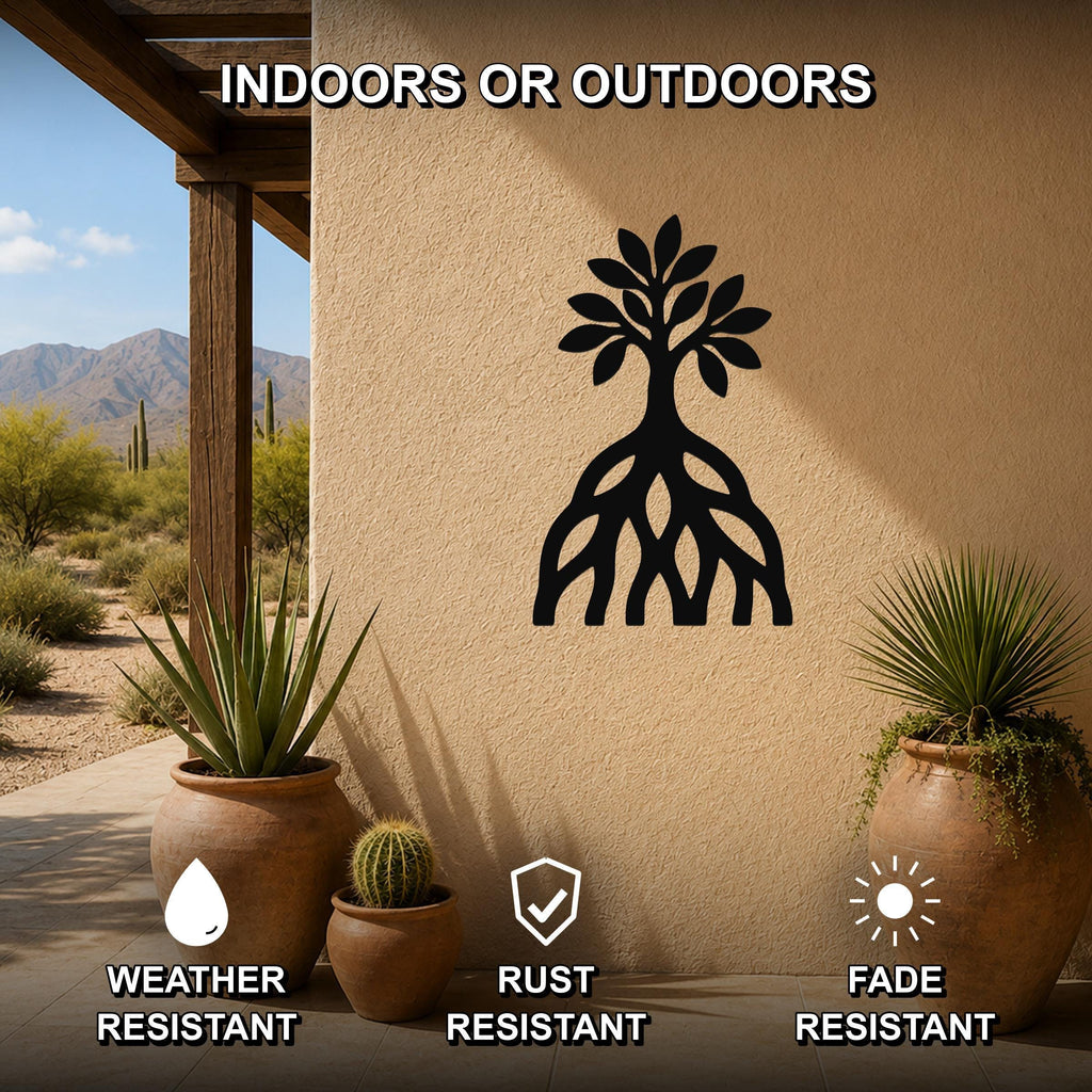 Black metal wall art silhouette of a mangrove tree with visible roots, mounted on an outdoor patio wall above potted plants.