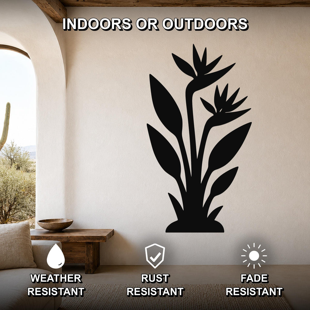 Black metal wall art of a Bird of Paradise plant silhouette, mounted on a beige wall above a wooden bench in a living room with an arched doorway.