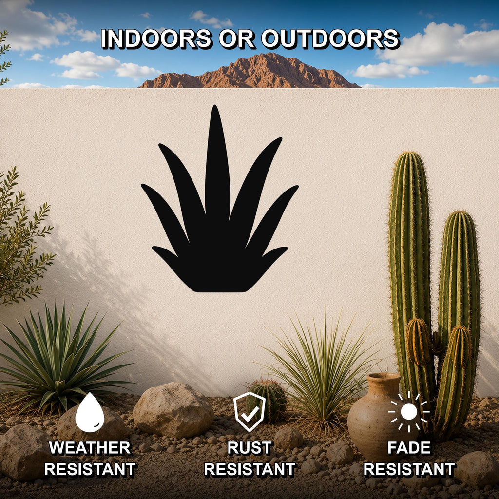 Black metal agave wall art silhouette mounted on a white outdoor wall, surrounded by cacti and desert plants in a patio setting.