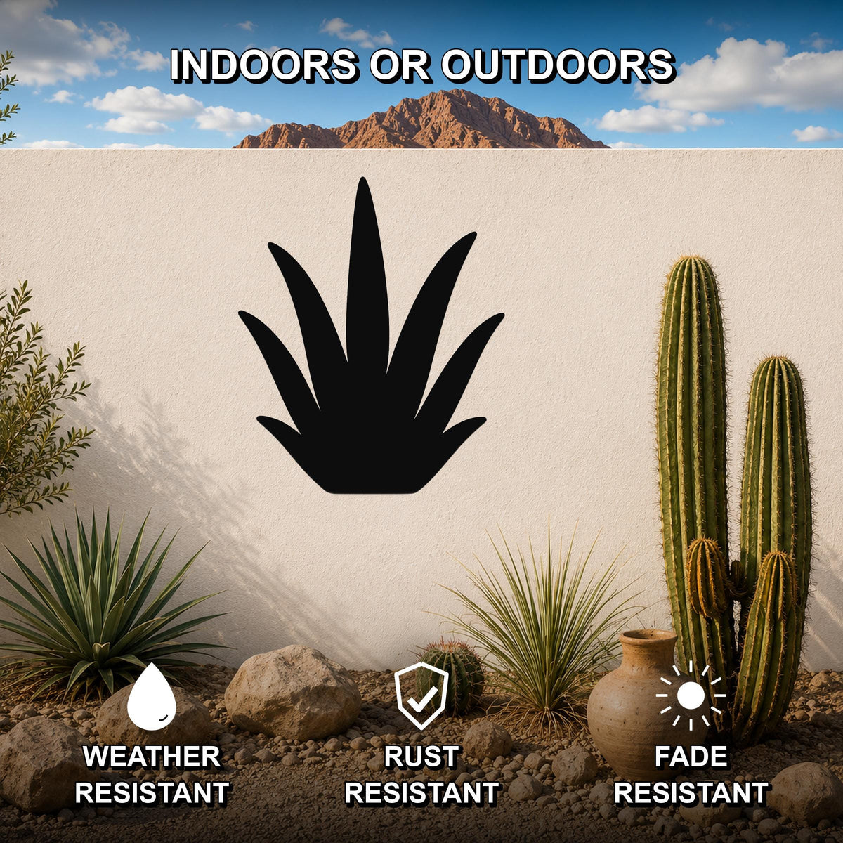 Black metal agave wall art silhouette mounted on a white outdoor wall, surrounded by cacti and desert plants in a patio setting.