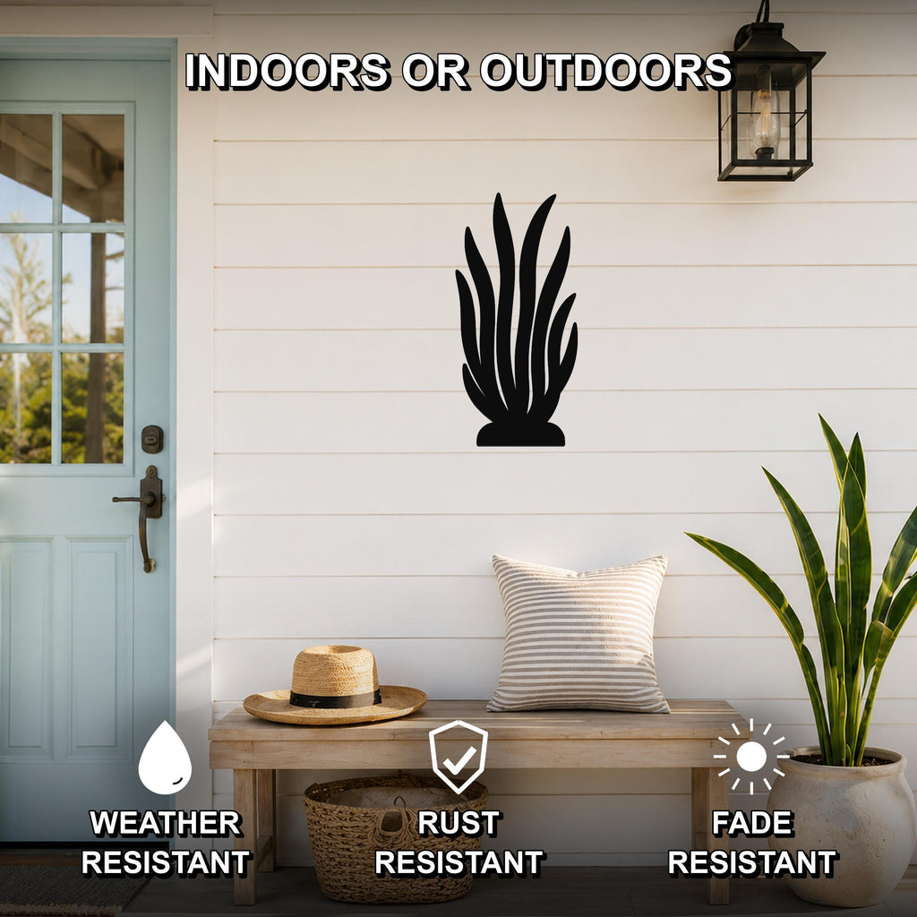 Black metal kelp wall art silhouette mounted on a white shiplap wall above a wooden bench on a porch, with text indicating it is weather, rust, and fade resistant for indoor or outdoor use.