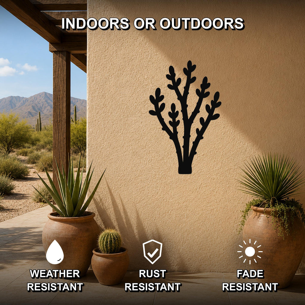 Black metal desert branch wall art with leafy cutouts, mounted on an outdoor patio wall above potted succulents.