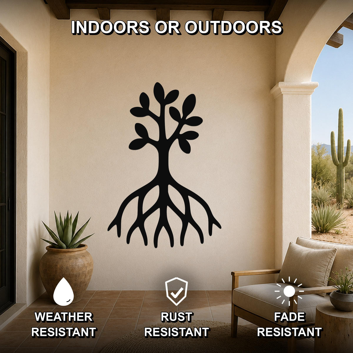 Black metal tree wall art with roots and leaves cutout, mounted on a beige outdoor patio wall above a chair and potted plant.