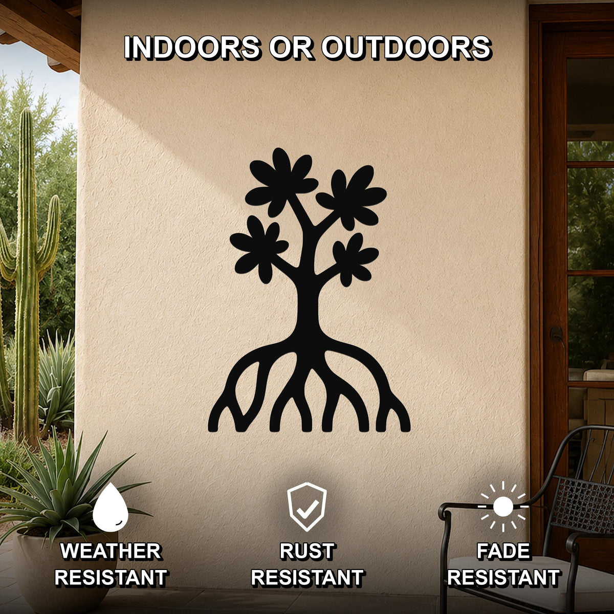 Black metal wall art featuring a tree silhouette with flower cutouts and visible roots, mounted on an outdoor patio wall.