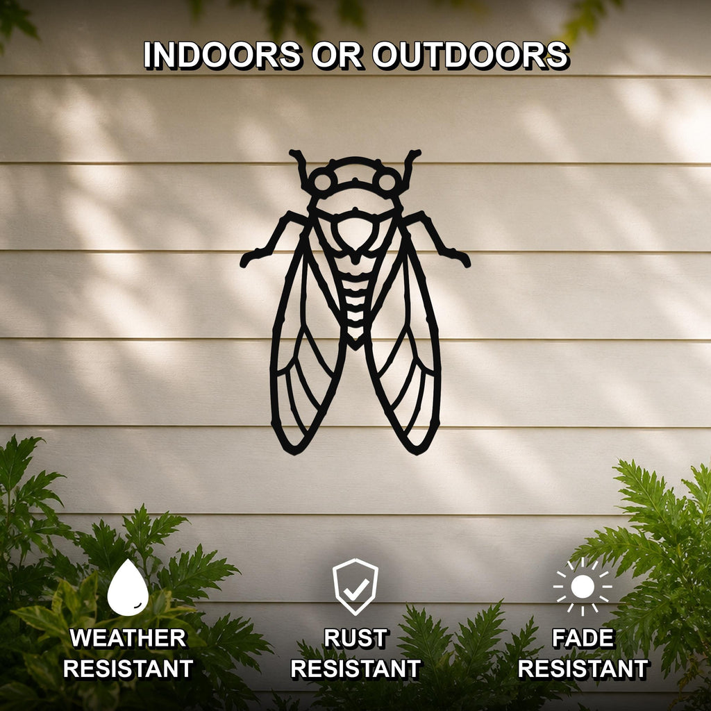 Black metal cicada wall art with detailed wing and body cutouts, mounted on a light-colored outdoor wall with greenery below.