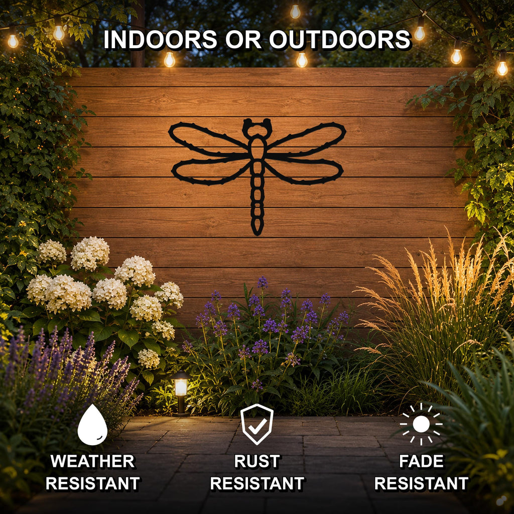Black metal dragonfly wall art with detailed wing cutouts, mounted on a wooden outdoor wall surrounded by plants and string lights, suitable for indoor or outdoor use.